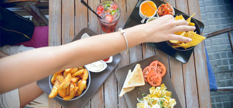 Girls-Hand-Reaching-accross-Mexican-Tapas-Cafe-Table